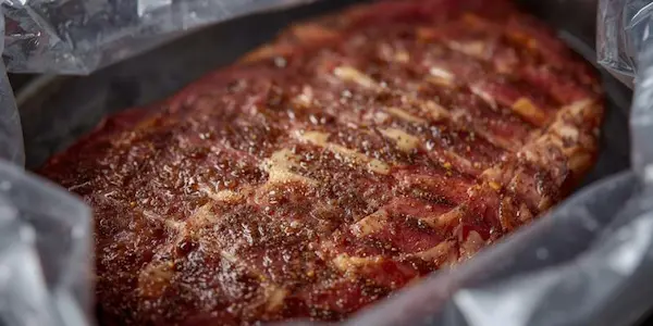 Juicy steak cooking in a vacuum-sealed bag in a sous vide water bath for perfect precision cooking